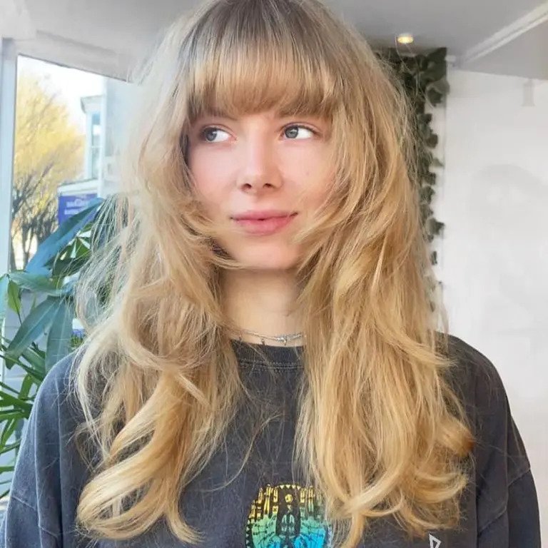 Long Blonde Wavy Wolf Cut with Blunt Bangs