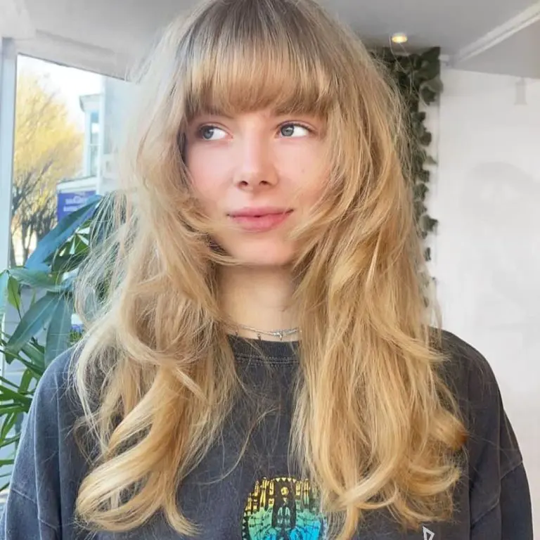 Long Blonde Layered Wolf Cut With Blunt Bangs