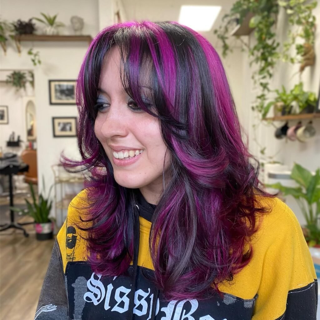 Medium Layered Hair With Purple Highlights and Curtain Bangs