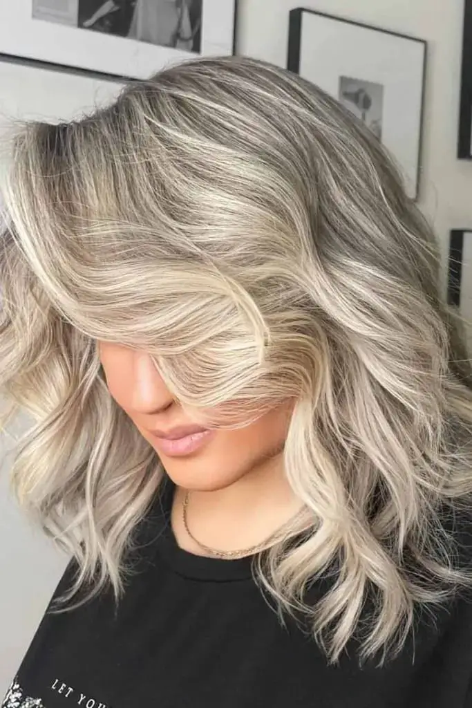  Voluminous Blonde Waves with Subtle Low Lights
