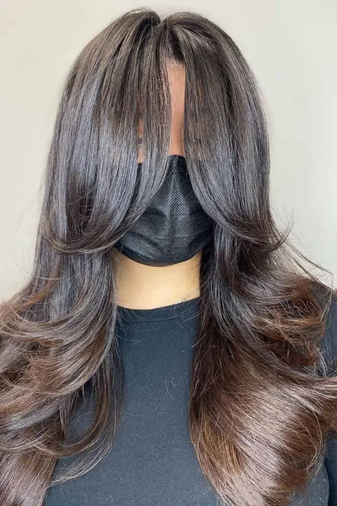 10 Fall Hair Trends You Must Try 5 Feathered Layers with Face-Framing Curtain Bangs